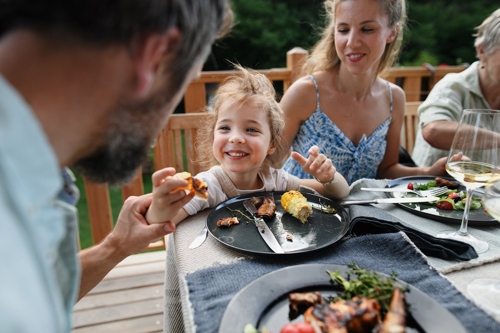 bigstock-Family-Eating-At-Barbecue-Part-456798265